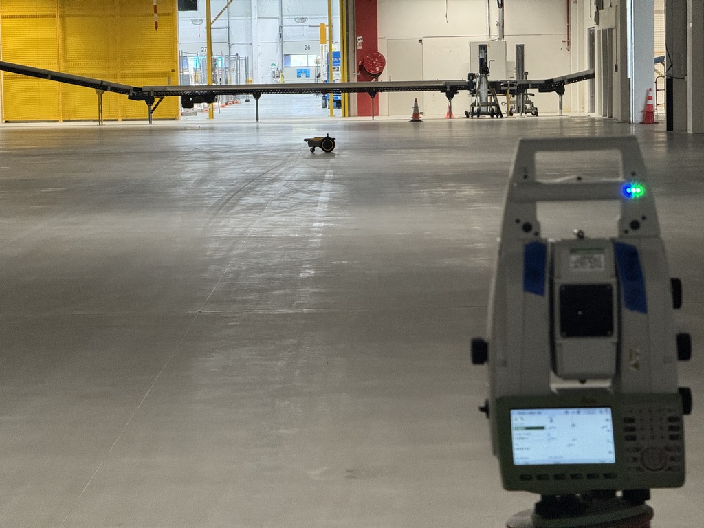Floor-marking robot and survey equipment at an Amazon site